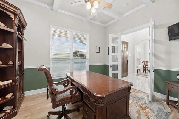 a view of a dining room with furniture and a chandelier