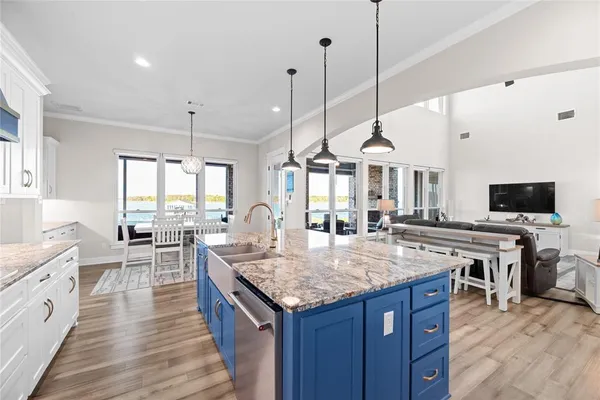 a kitchen with granite countertop a stove and a wooden floor