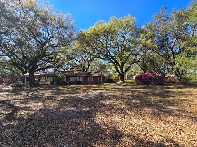 4643 Keyser Lane Pace, FL 32571 - Photo 3 of 14 a front view of a house with large trees