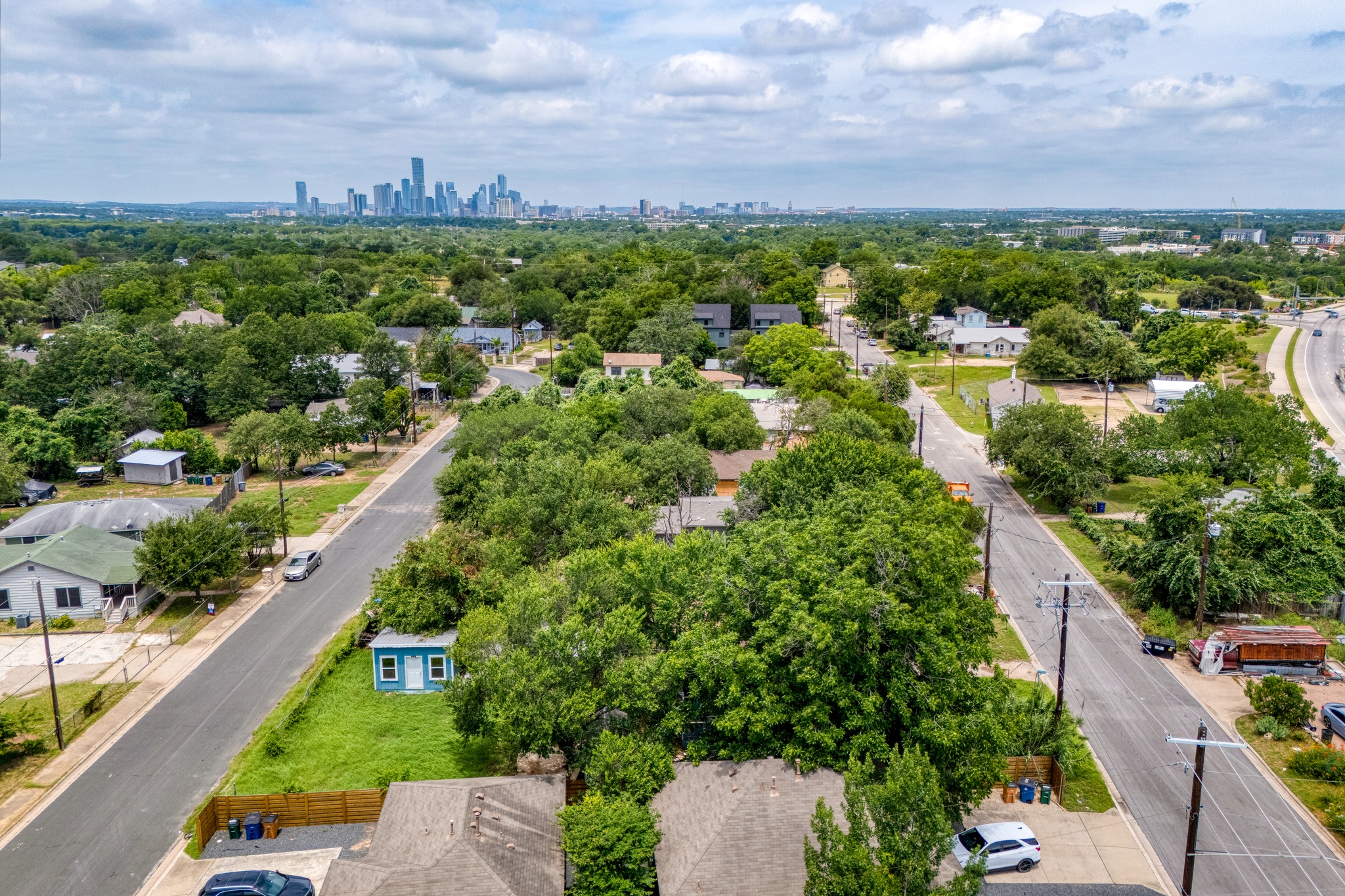 6409 Del Monte Road Austin, TX 78741 - Photo 12 of 15 An aerial perspective reveals a vibrant neighborhood with a distant cityscape and abundant mature trees.