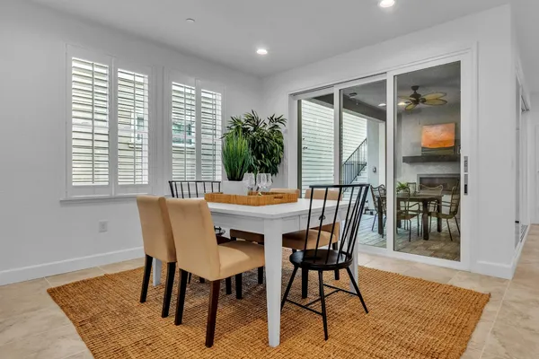 a living room with furniture a flat screen tv and kitchen view