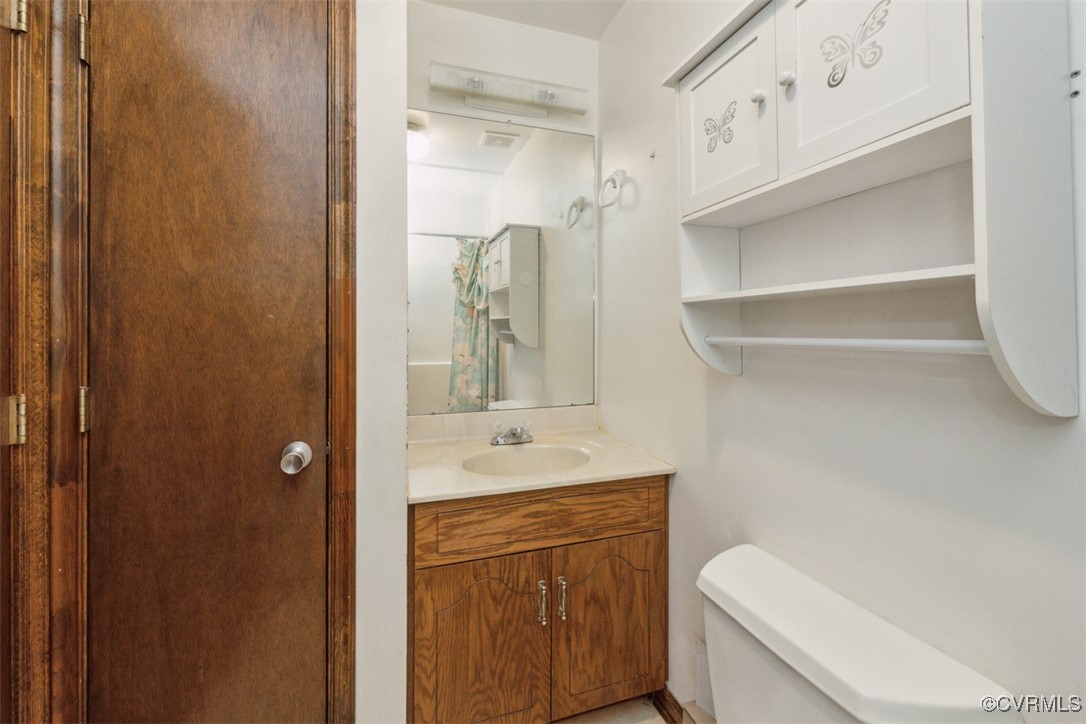 7303 Old Town Road Prince George, VA 23875 - Photo 11 of 24 Bathroom featuring vanity and toilet