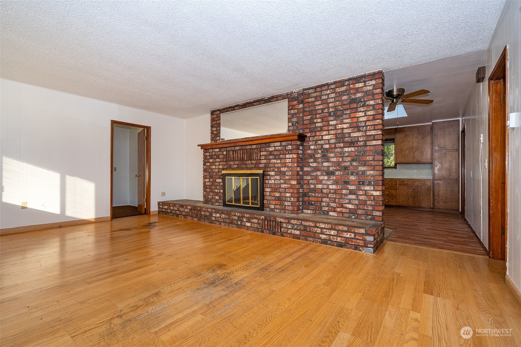 431 Tucker Road Toledo, WA 98591 - Photo 7 of 40 a view of empty room with a fireplace and wooden floor