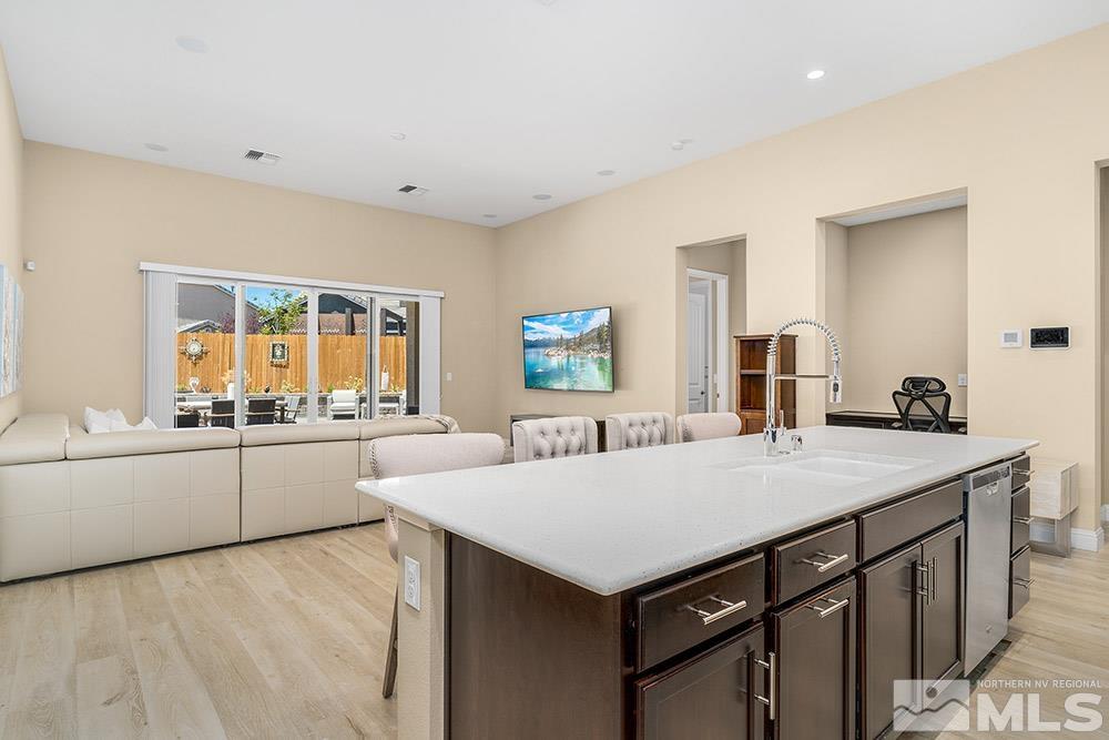 9545 Hawkshead Road Reno, NV 89521 - Photo 11 of 29 a kitchen with a stove a sink and a refrigerator