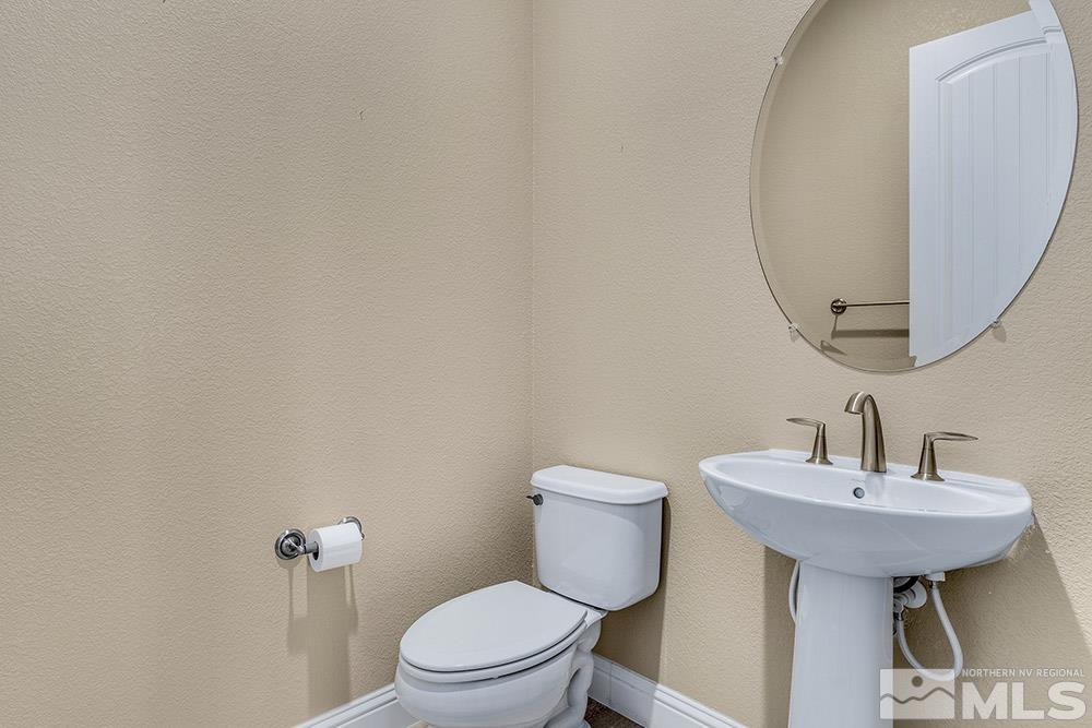 9545 Hawkshead Road Reno, NV 89521 - Photo 5 of 29 a bathroom with a sink toilet and mirror