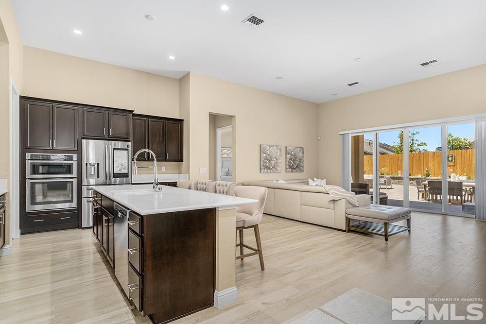 9545 Hawkshead Road Reno, NV 89521 - Photo 10 of 29 a large kitchen with a large counter top appliances and cabinets