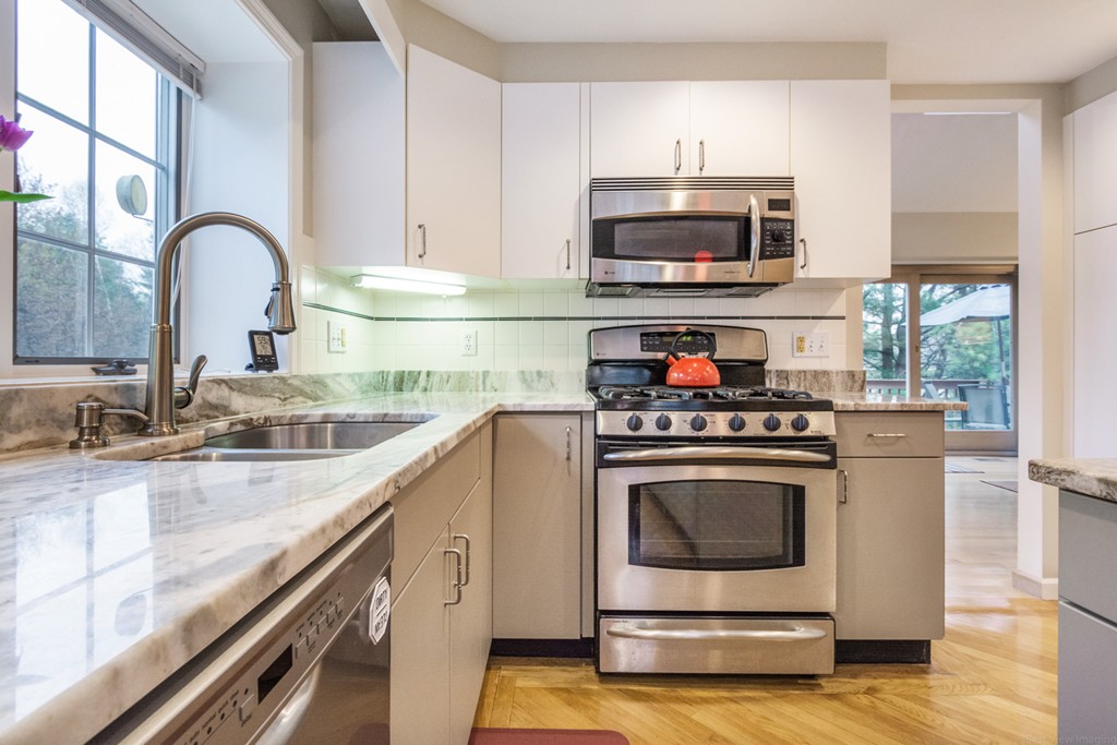 9 Powder Hill Way, Unit 9 Westborough, MA 01581 - Photo 11 of 30 a kitchen with granite countertop a stove and a sink
