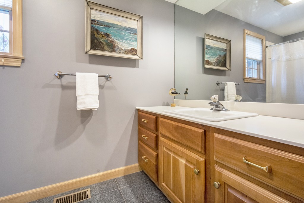 9 Powder Hill Way, Unit 9 Westborough, MA 01581 - Photo 16 of 30 a bathroom with a sink a mirror and a shower