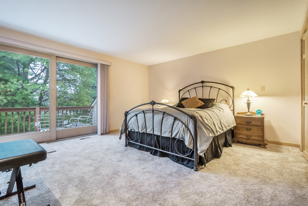 9 Powder Hill Way, Unit 9 Westborough, MA 01581 - Photo 22 of 30 a spacious bedroom with a bed and a window