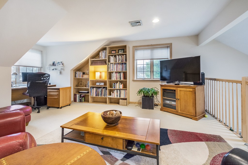 9 Powder Hill Way, Unit 9 Westborough, MA 01581 - Photo 26 of 30 a living room with furniture and a flat screen tv