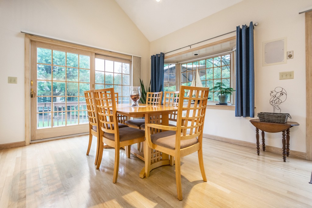 9 Powder Hill Way, Unit 9 Westborough, MA 01581 - Photo 7 of 30 a view of a dining room with furniture a chandelier and wooden floor