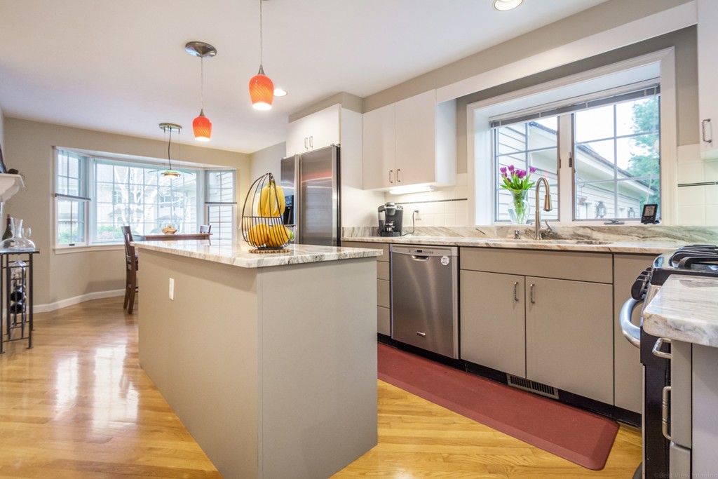9 Powder Hill Way, Unit 9 Westborough, MA 01581 - Photo 10 of 30 a kitchen with stainless steel appliances granite countertop a stove a sink and a refrigerator