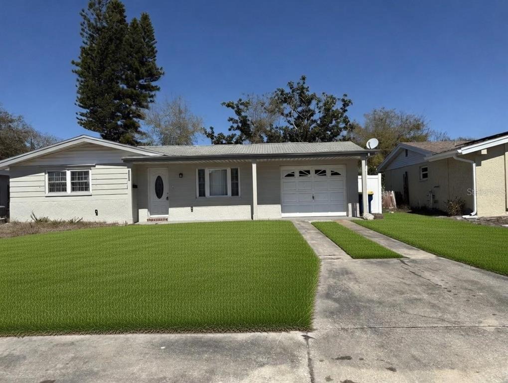 4033 Newcastle Drive New Port Richey, FL 34652 - Photo 1 of 12 a front view of a house with a garden