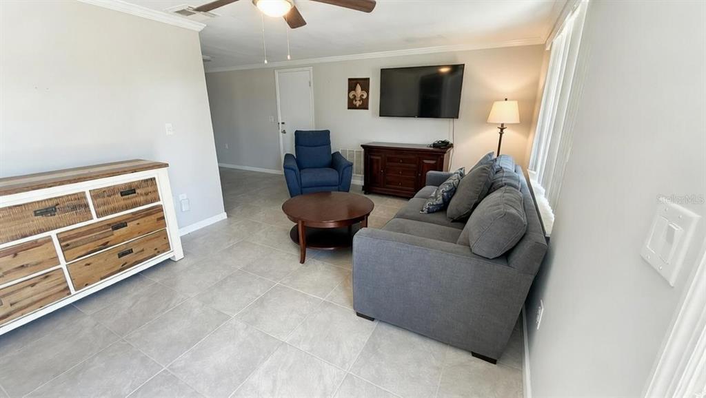 4033 Newcastle Drive New Port Richey, FL 34652 - Photo 12 of 12 a living room with furniture and a flat screen tv