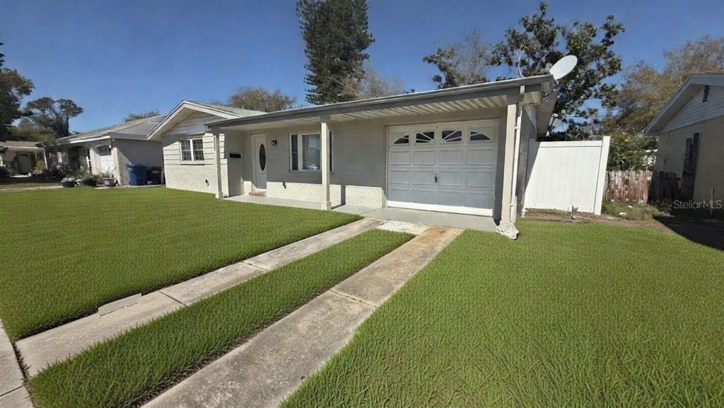4033 Newcastle Drive New Port Richey, FL 34652 - Photo 2 of 12 a front view of a house with a yard