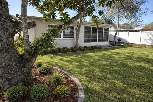 a view of a house with backyard and sitting area