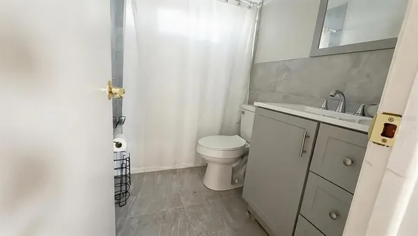 a bathroom with a toilet and a shower