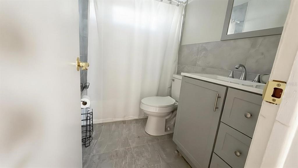 4033 Newcastle Drive New Port Richey, FL 34652 - Photo 4 of 12 a bathroom with a toilet and a shower