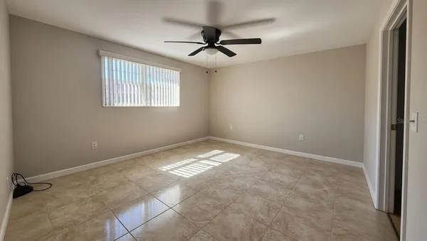 a view of empty room with ceiling fan