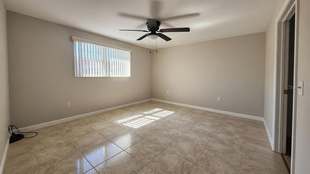 4033 Newcastle Drive New Port Richey, FL 34652 - Photo 8 of 12 a view of empty room with ceiling fan