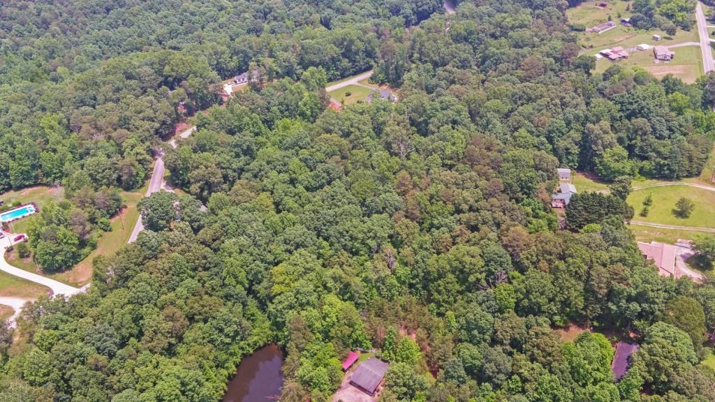 6755 Jake Kemp Road Murrayville, GA 30564 - Photo 6 of 22 a aerial view of a house with a yard and garden