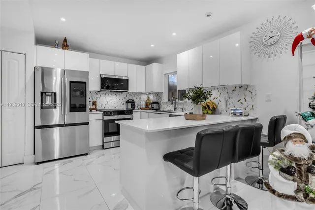 a kitchen with a sink stainless steel appliances and cabinets
