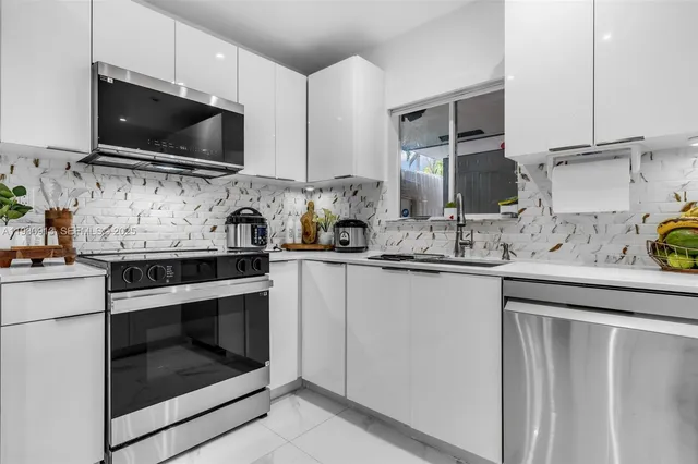 a kitchen with a sink stove and microwave