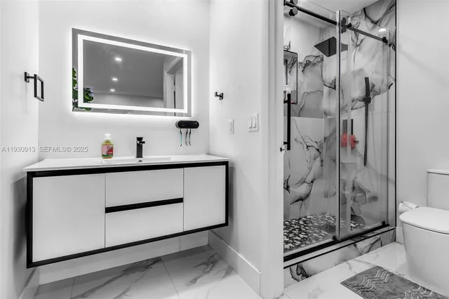 a bathroom with a shower sink and mirror