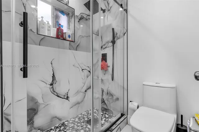 a bathroom with a toilet and shower