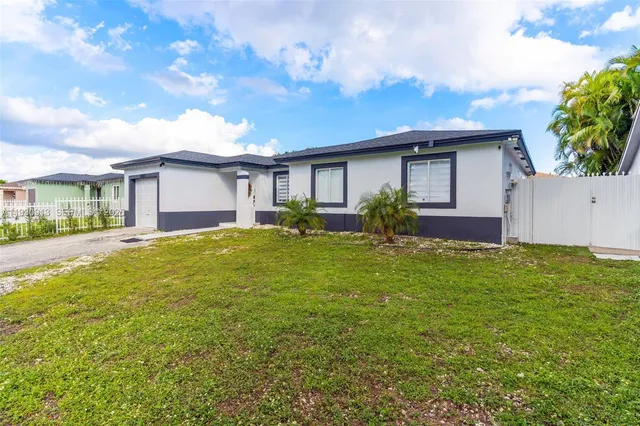 a front view of house with yard and trees