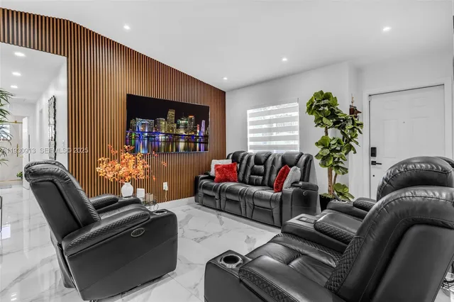 a living room with furniture and a potted plant