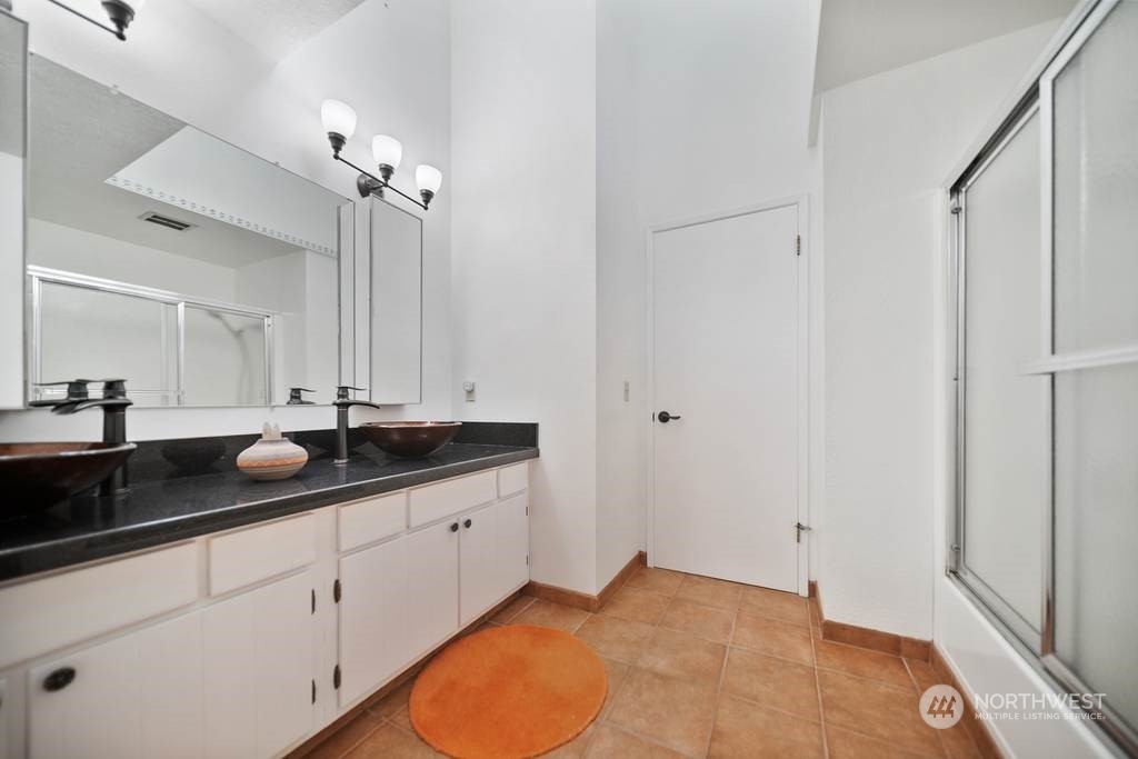 1171 Big Pine Way Forks, WA 98331 - Photo 21 of 40 a bathroom with a granite countertop sink and a mirror