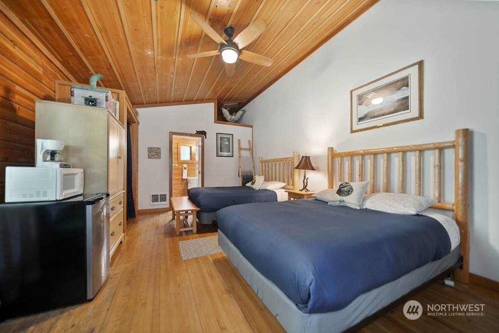 1171 Big Pine Way Forks, WA 98331 - Photo 29 of 40 a spacious bedroom with a bed and wooden floor