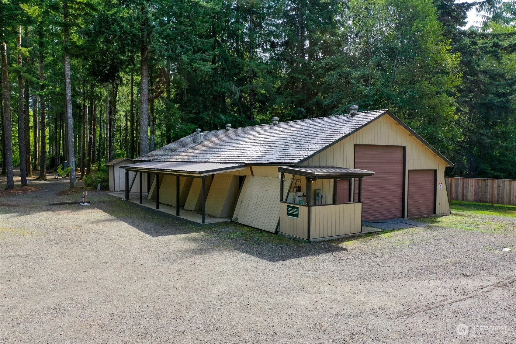 1171 Big Pine Way Forks, WA 98331 - Photo 34 of 40 a wooden house with tall trees in the background