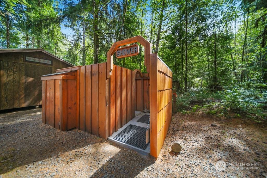 1171 Big Pine Way Forks, WA 98331 - Photo 36 of 40 a view of a small house with wooden fence next to a yard