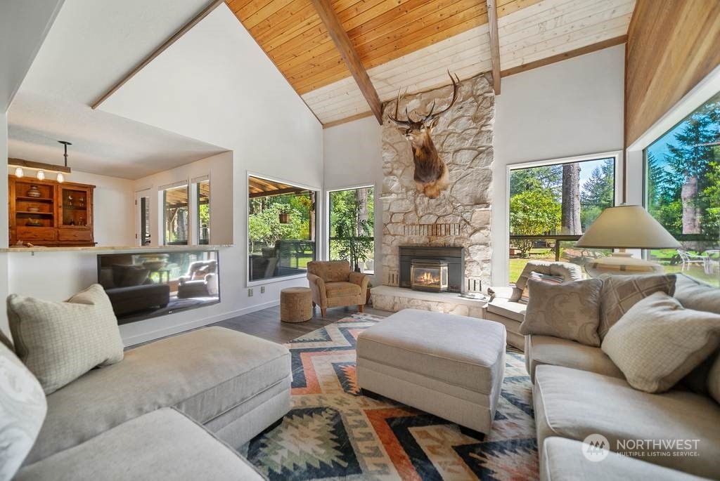 1171 Big Pine Way Forks, WA 98331 - Photo 6 of 40 a living room with furniture fireplace and a floor to ceiling window