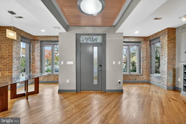 a view of an entryway with wooden floor and door