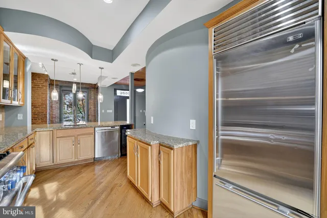 a kitchen with granite countertop stainless steel appliances and white cabinets