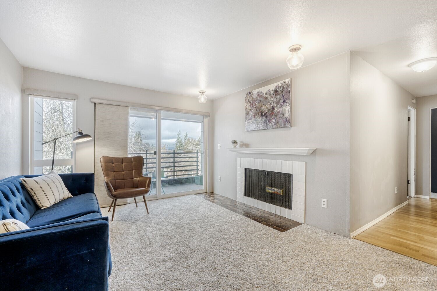 3501 Southwest Holden Street, Unit 303 Seattle, WA 98126 - Photo 12 of 30 a living room with furniture and a fireplace