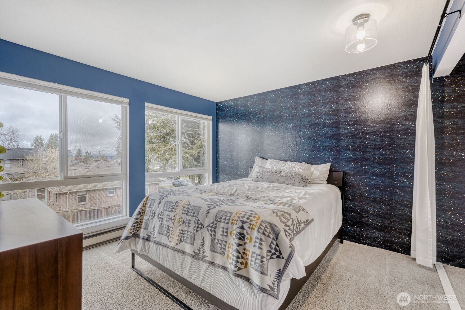 3501 Southwest Holden Street, Unit 303 Seattle, WA 98126 - Photo 13 of 30 a bedroom with a bed lamp and a large window