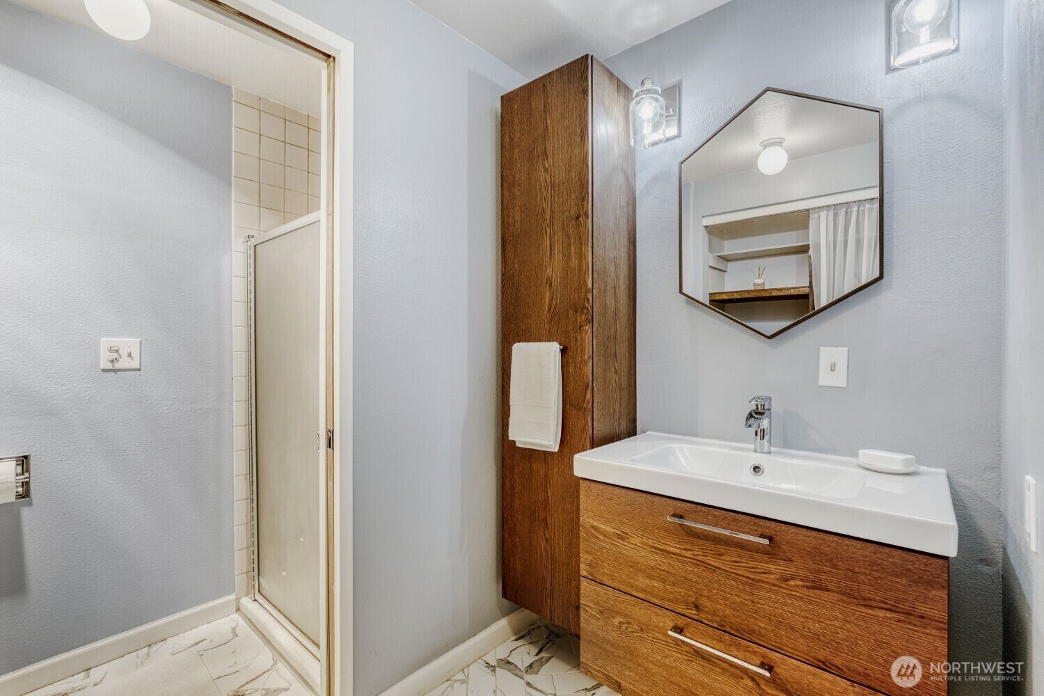 3501 Southwest Holden Street, Unit 303 Seattle, WA 98126 - Photo 17 of 30 a bathroom with a sink a light fixture and a mirror