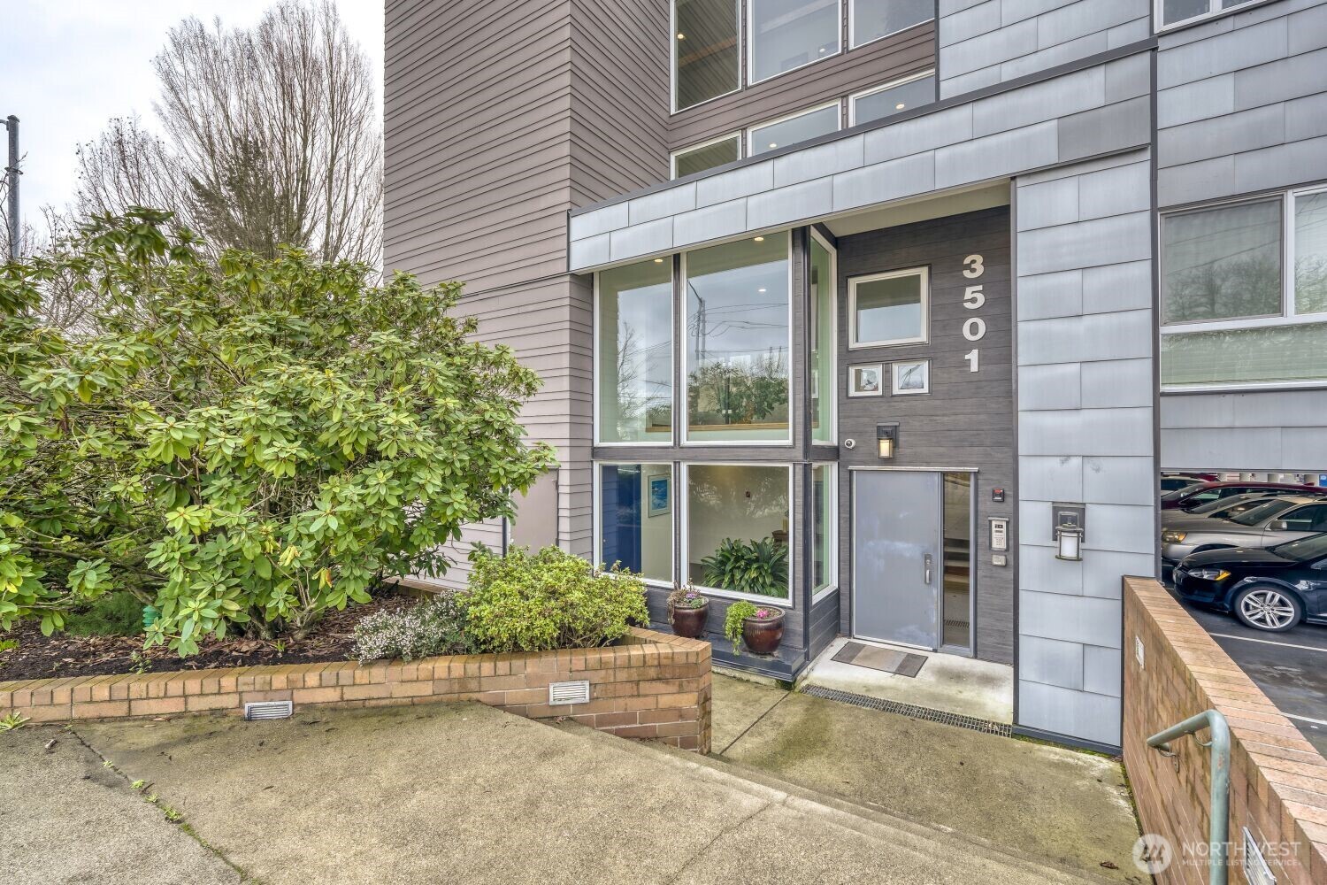3501 Southwest Holden Street, Unit 303 Seattle, WA 98126 - Photo 3 of 30 a view of a patio with table and chairs and potted plants