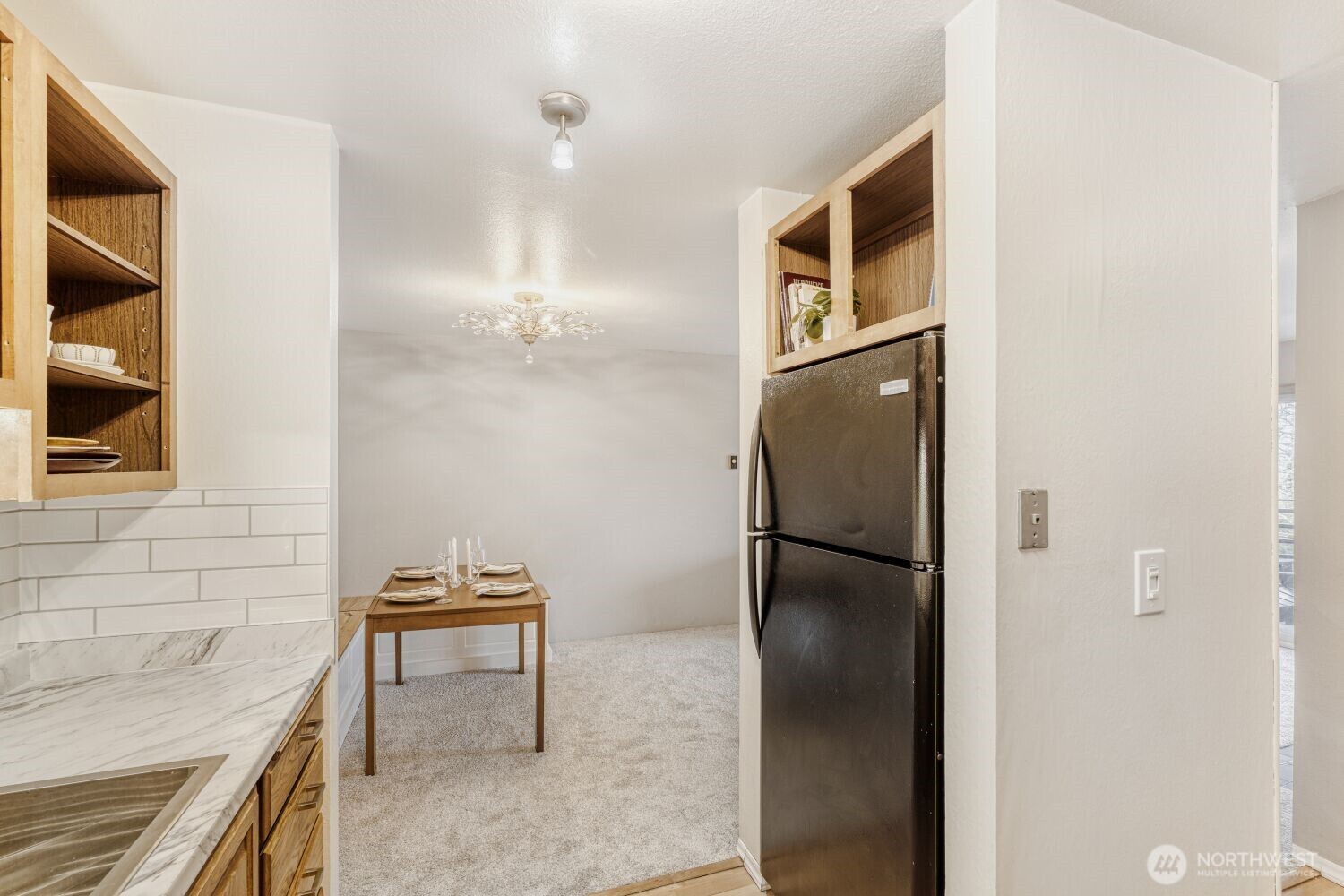 3501 Southwest Holden Street, Unit 303 Seattle, WA 98126 - Photo 6 of 30 a kitchen with a refrigerator and cabinets