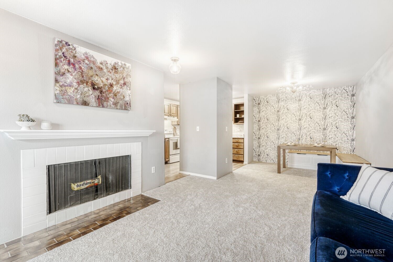 3501 Southwest Holden Street, Unit 303 Seattle, WA 98126 - Photo 10 of 30 a living room with furniture and a fireplace