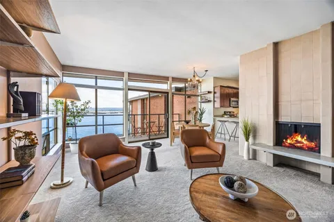 a living room with furniture and a floor to ceiling window