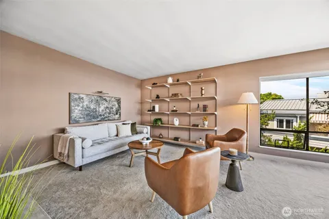 a living room with furniture and a painting on the wall