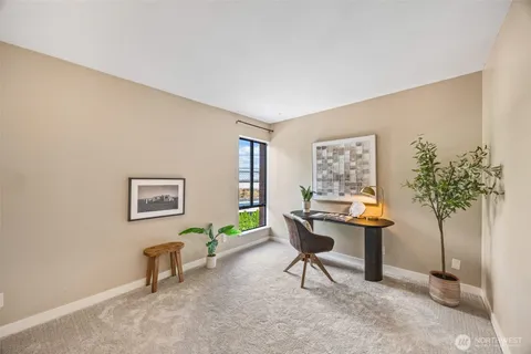 a view of a livingroom with furniture and a potted plant
