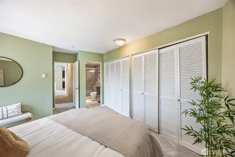 a bedroom with a bed and a potted plant