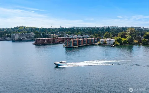 a view of a lake with boats and trees in the background