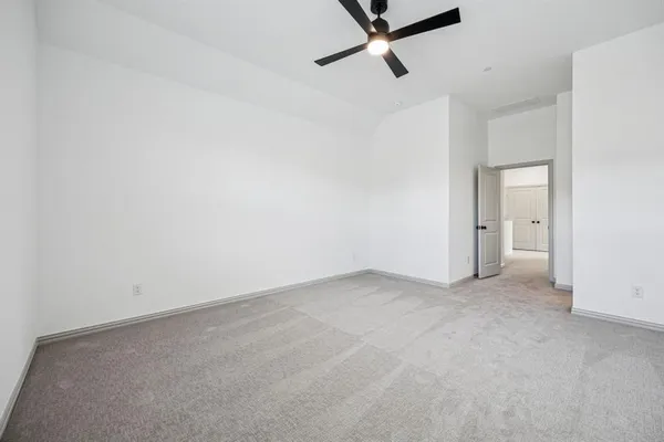 a view of a room with a ceiling fan